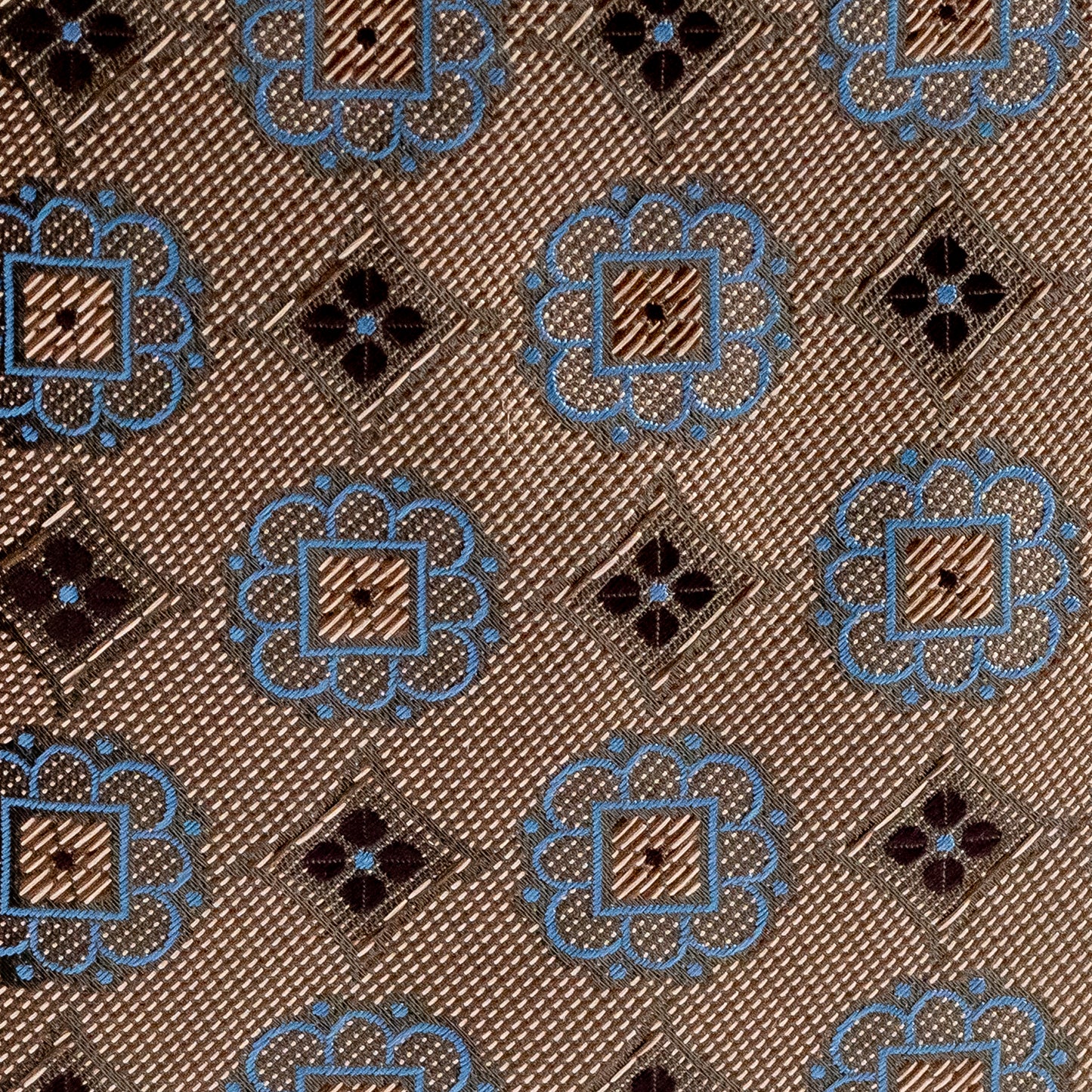 Patterned fabric with blue and black designs on a brown background