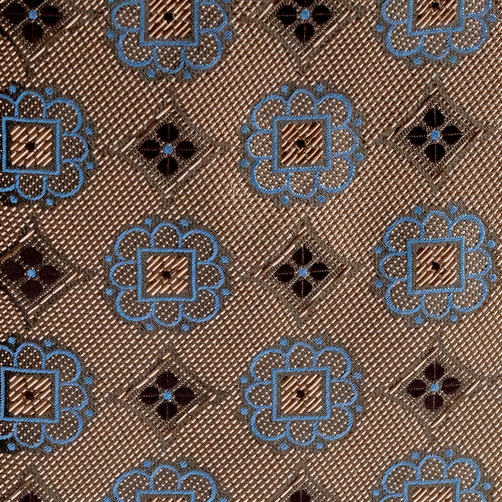 Patterned fabric with blue and black designs on a brown background