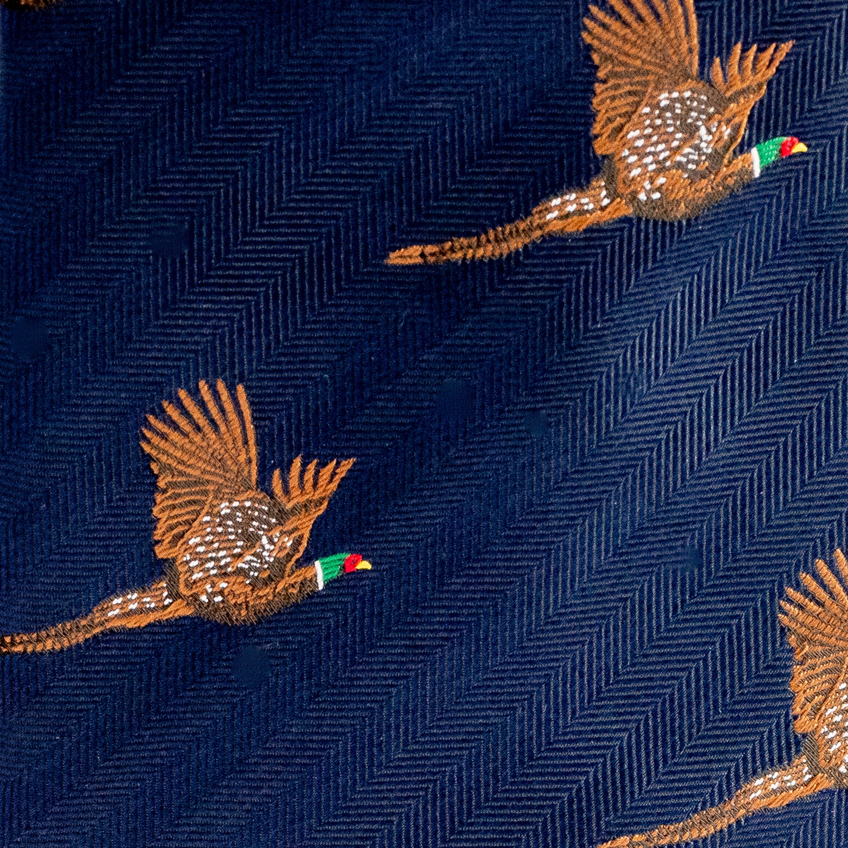 Embroidered pheasants on a navy fabric with a herringbone pattern