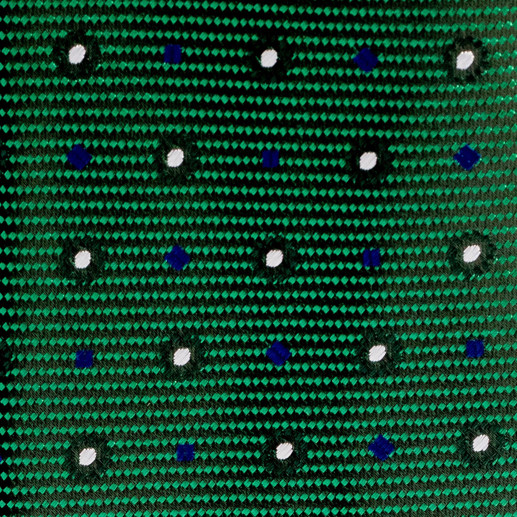 Close-up of a green fabric with blue and white dot pattern