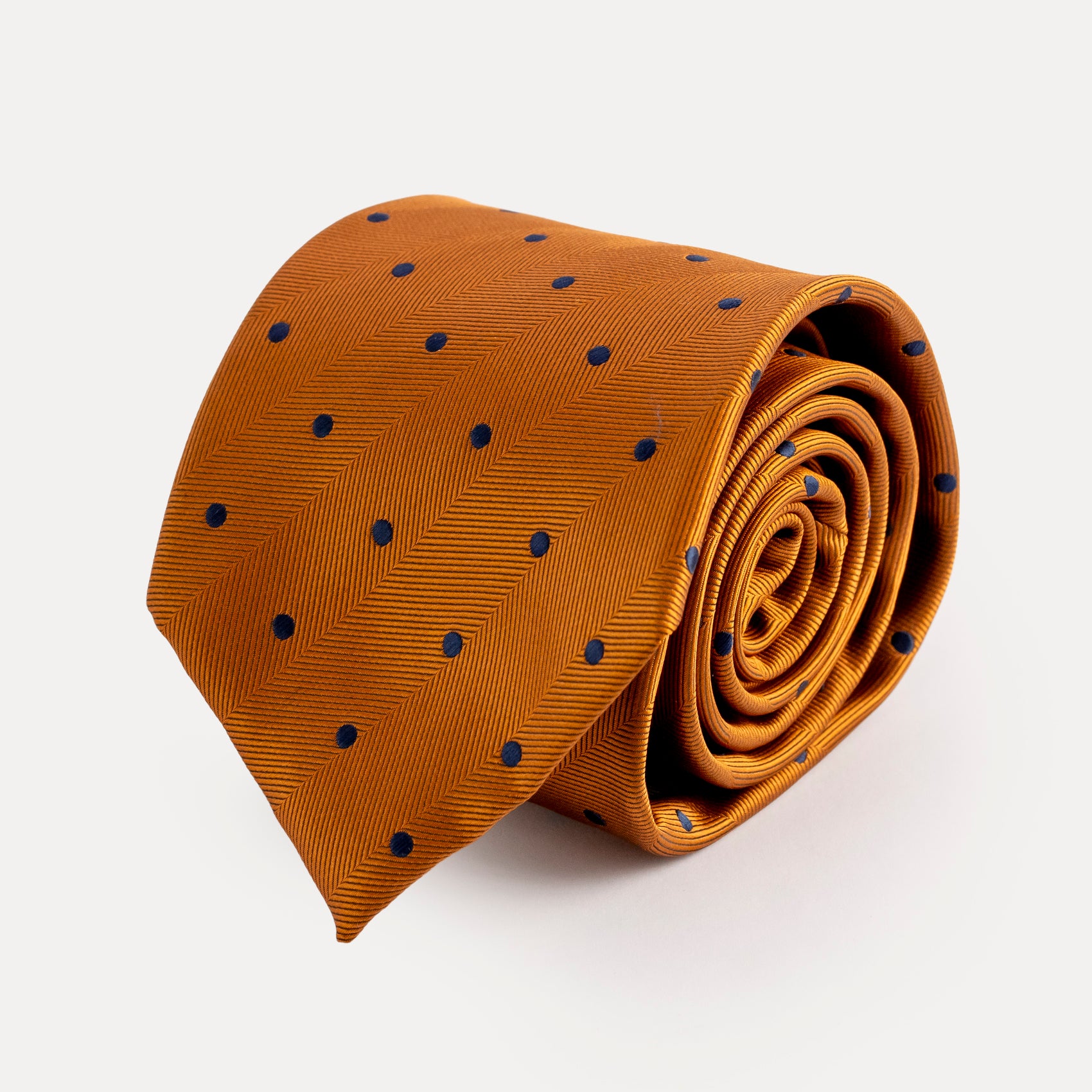 Brown tie with blue polka dots on a white background