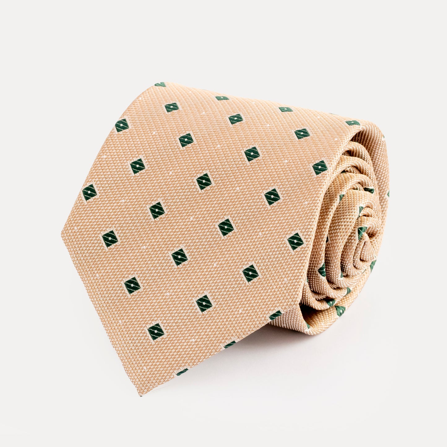 Beige tie with green pattern on a white background