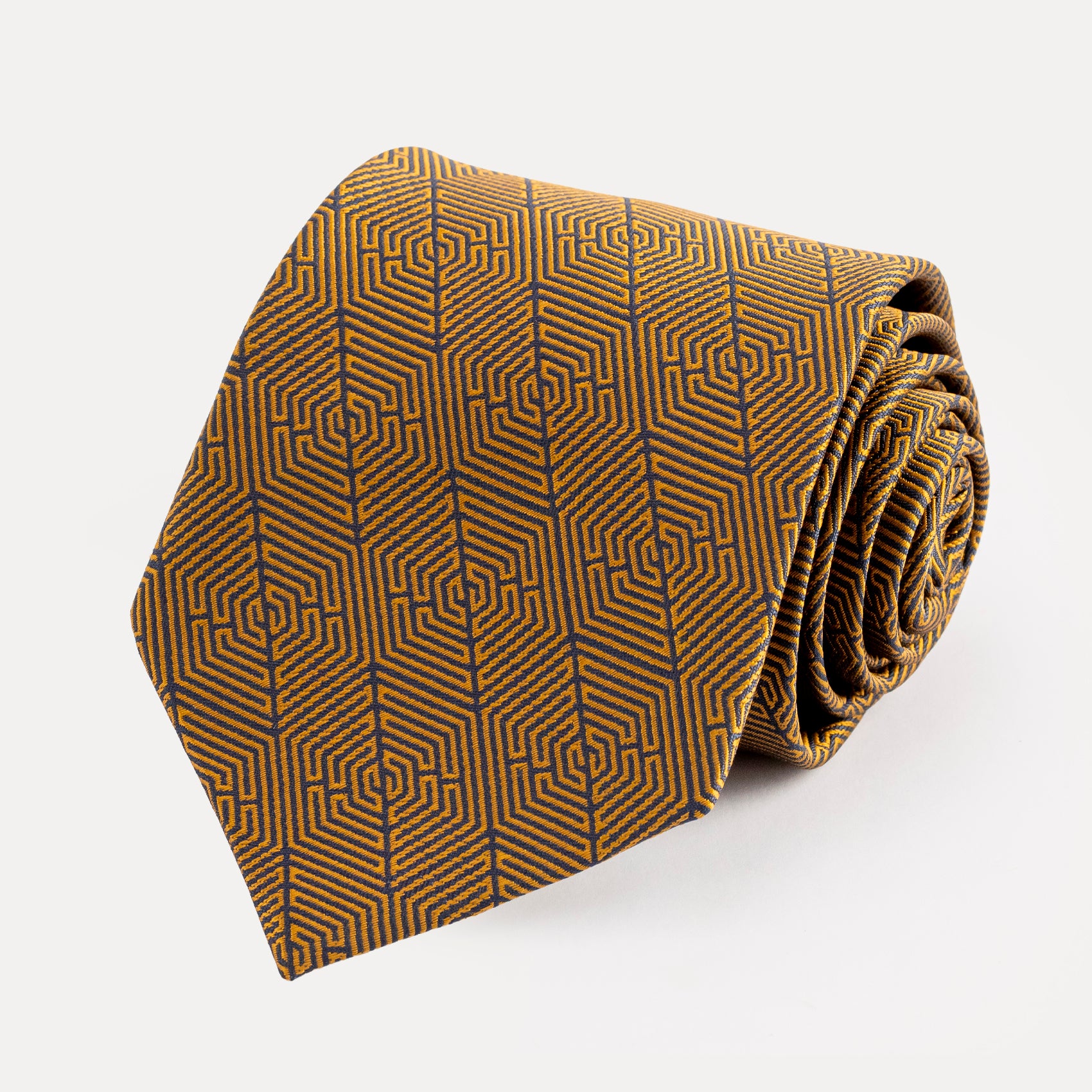 Folded brown tie with geometric pattern on a white background