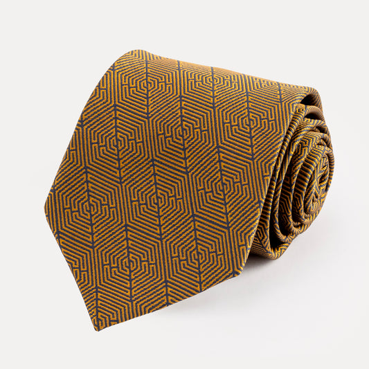 Folded brown tie with geometric pattern on a white background