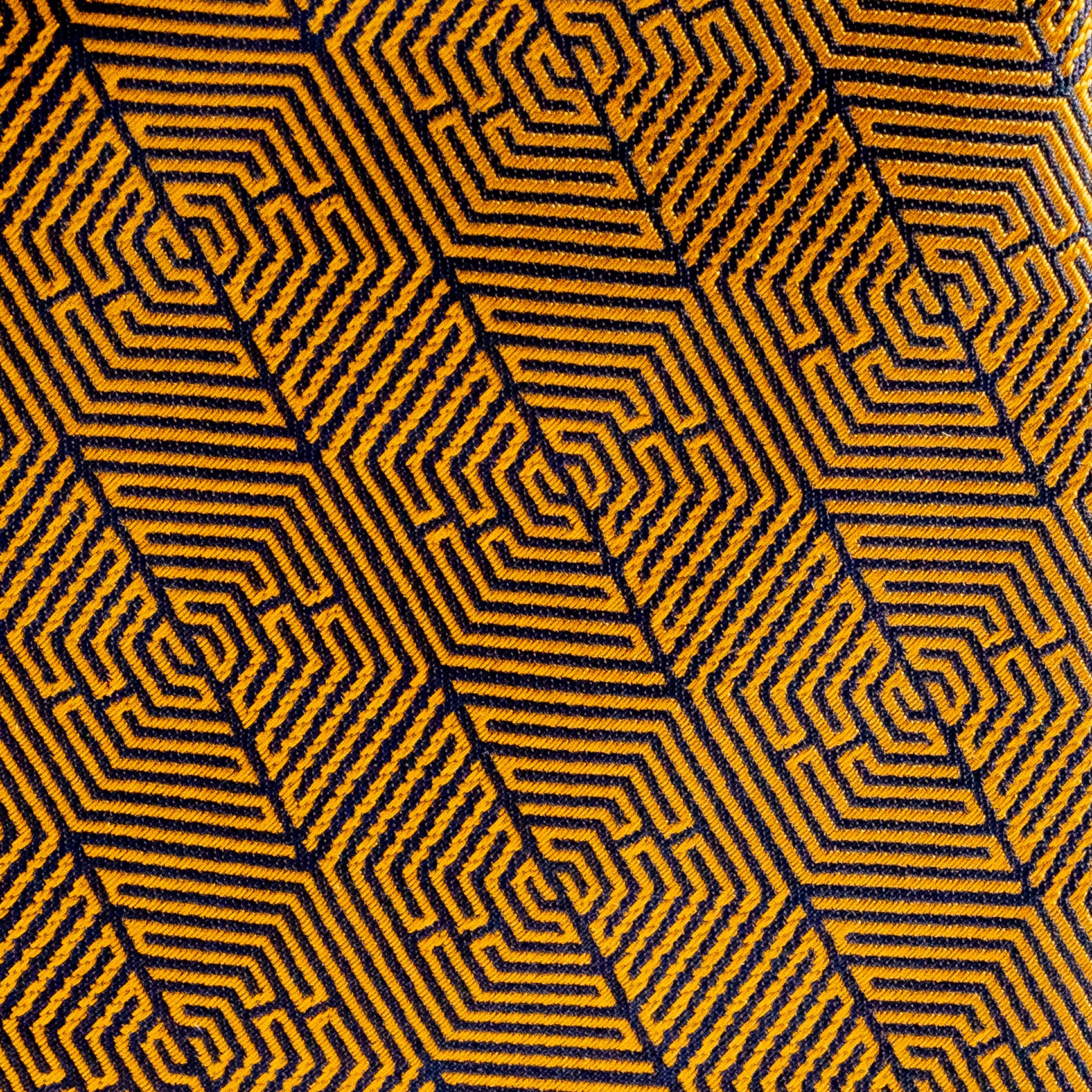 Hexagonal pattern with yellow and black lines on a textured fabric background