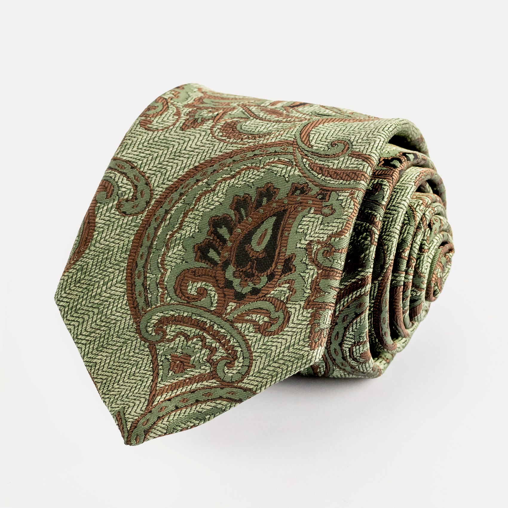 Green paisley tie on a white background