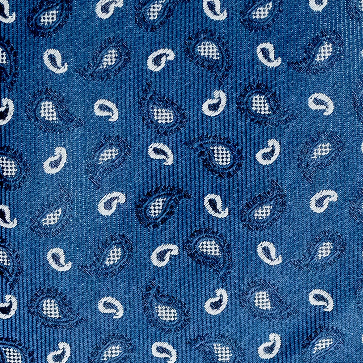 Close-up of a blue patterned fabric with white paisley designs