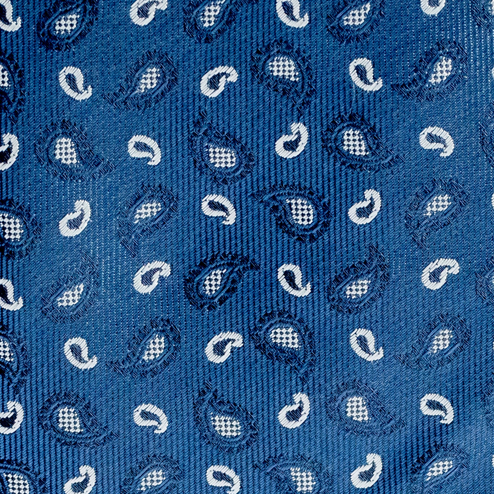 Close-up of a blue patterned fabric with white paisley designs