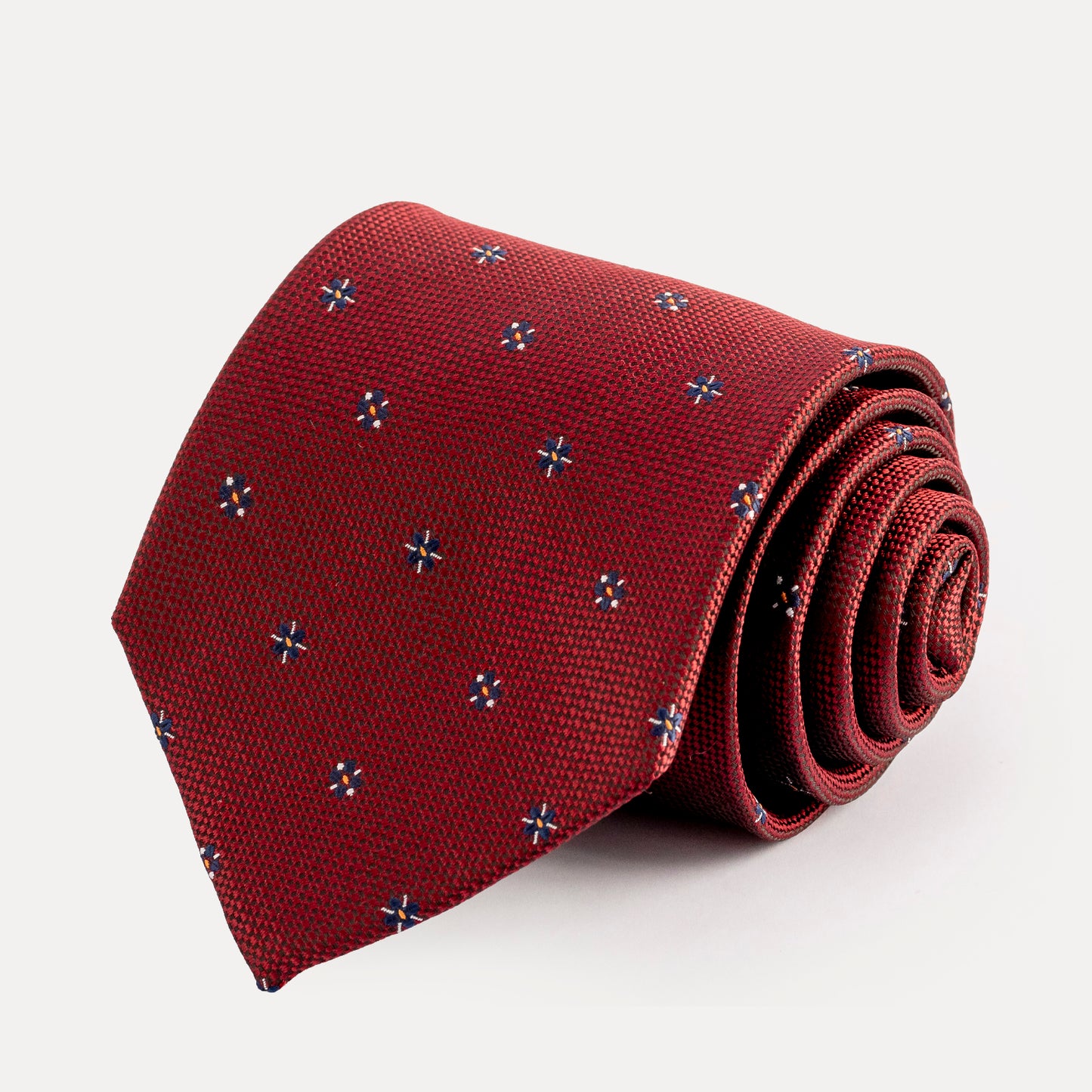 Red tie with a subtle pattern on a white background