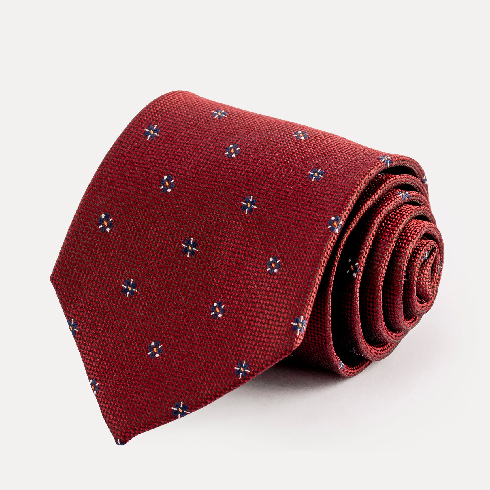 Red tie with a subtle pattern on a white background