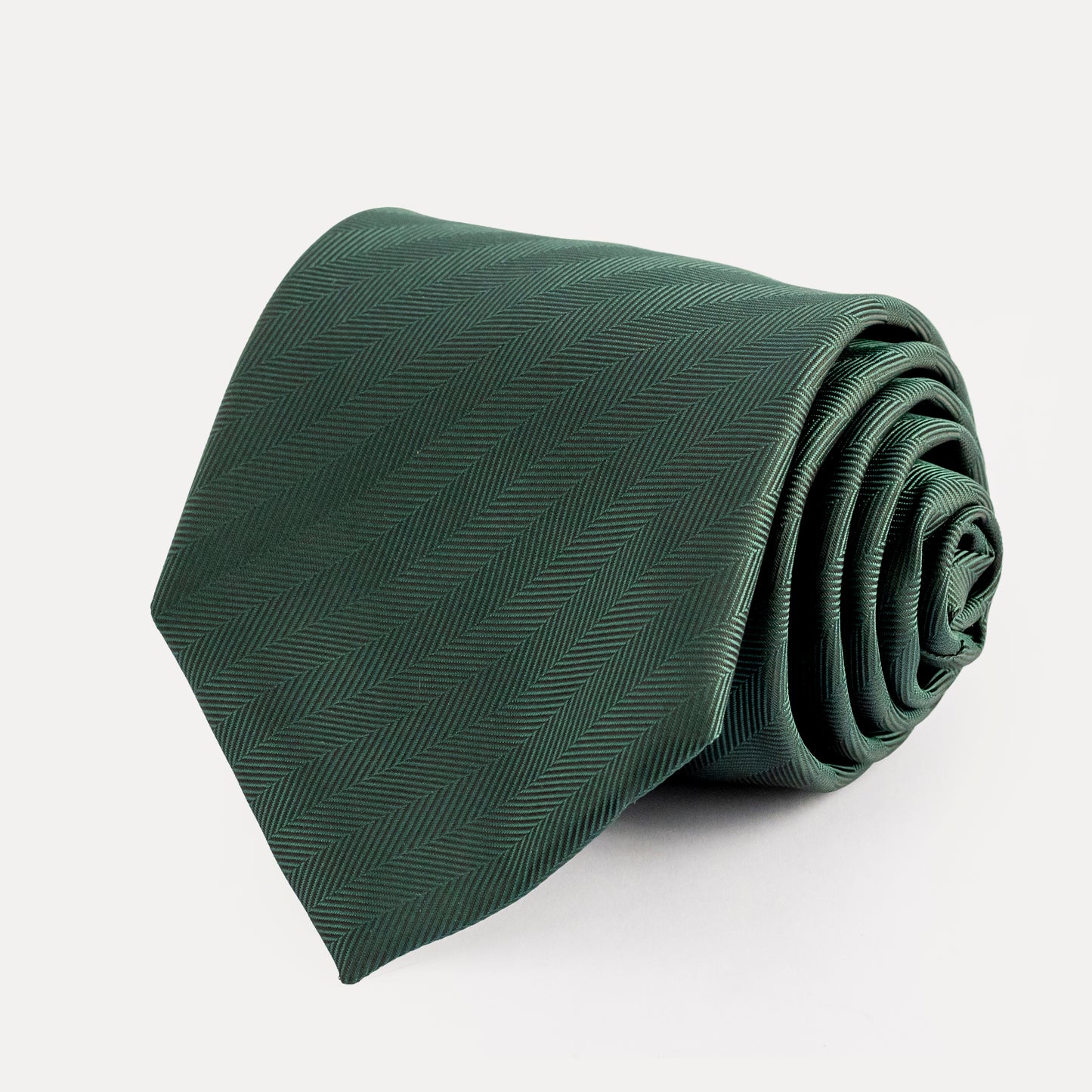 Green tie with a subtle pattern on a white background