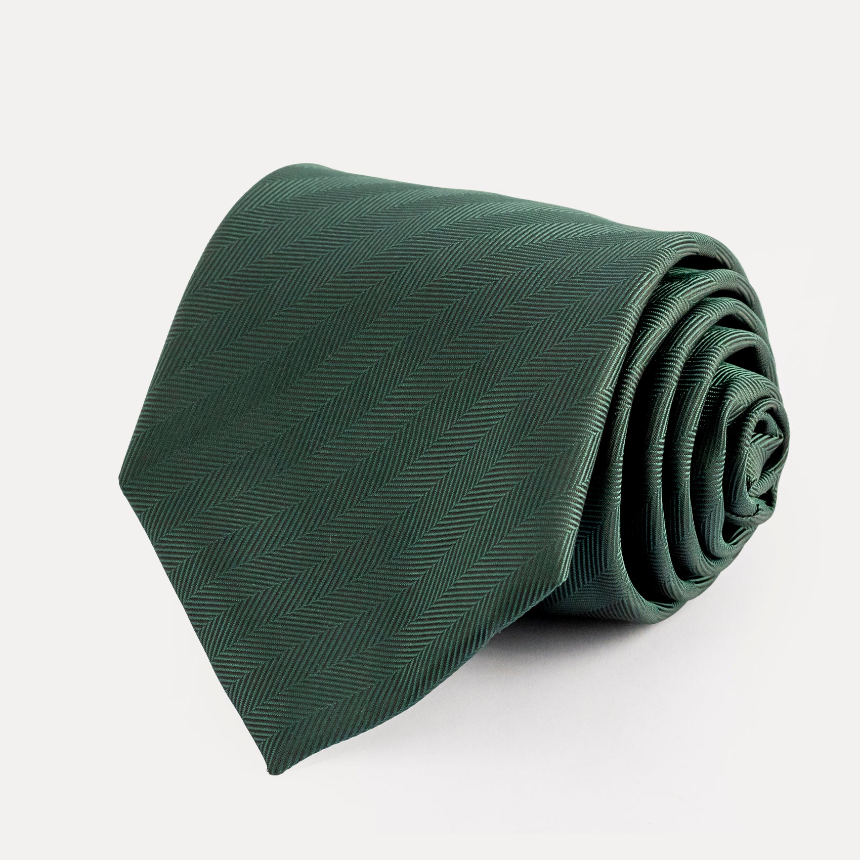 Green tie with a subtle pattern on a white background