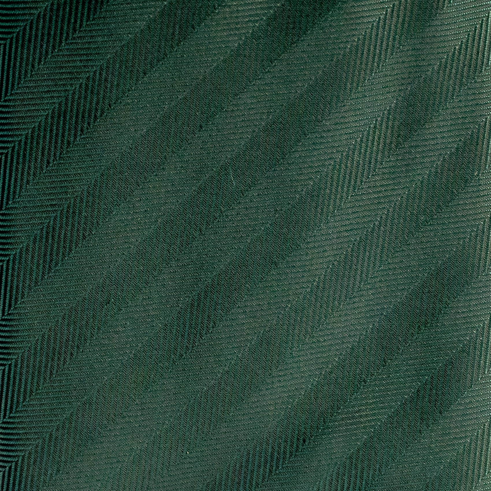 Textured green fabric with a herringbone pattern