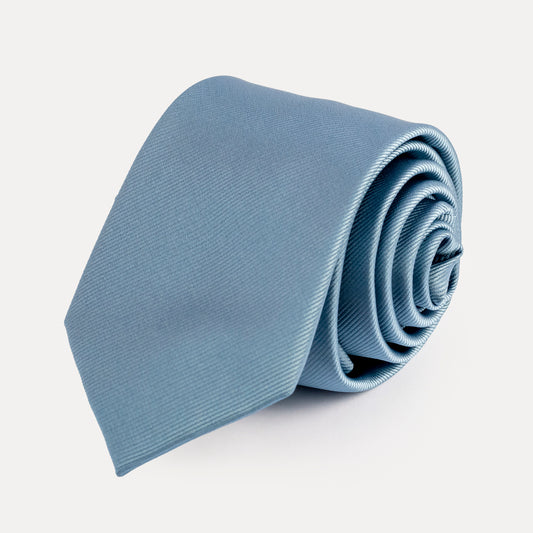 Rolled light blue tie on a white background
