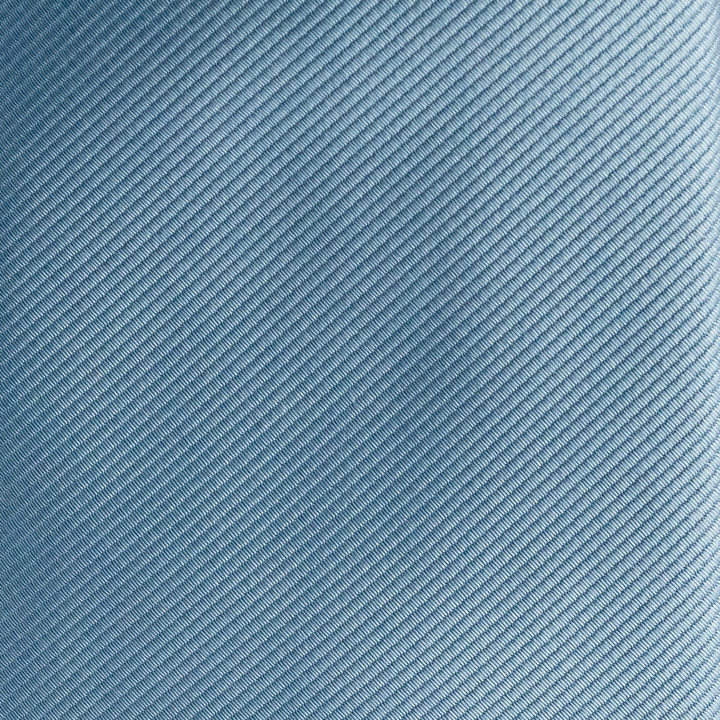 Close-up of a textured blue fabric with a subtle pattern