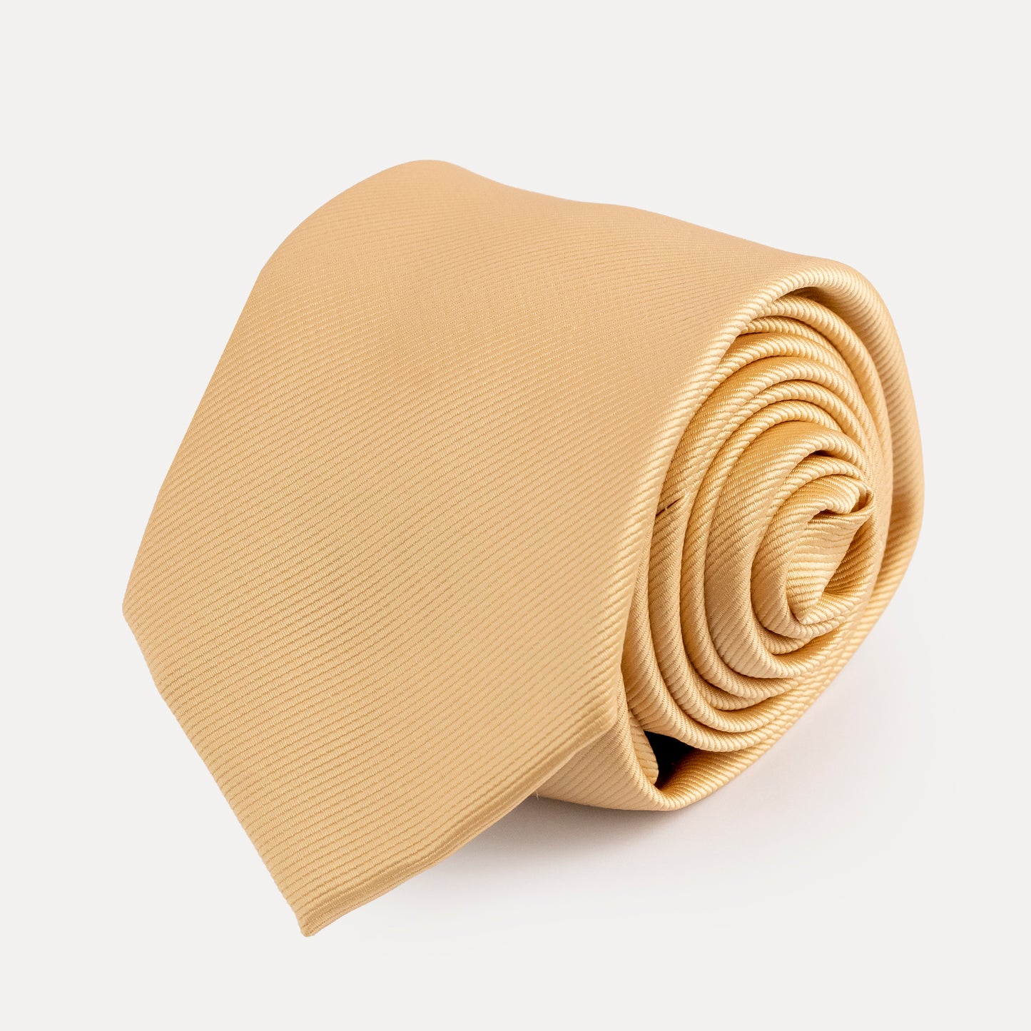 Rolled beige tie on a light gray background