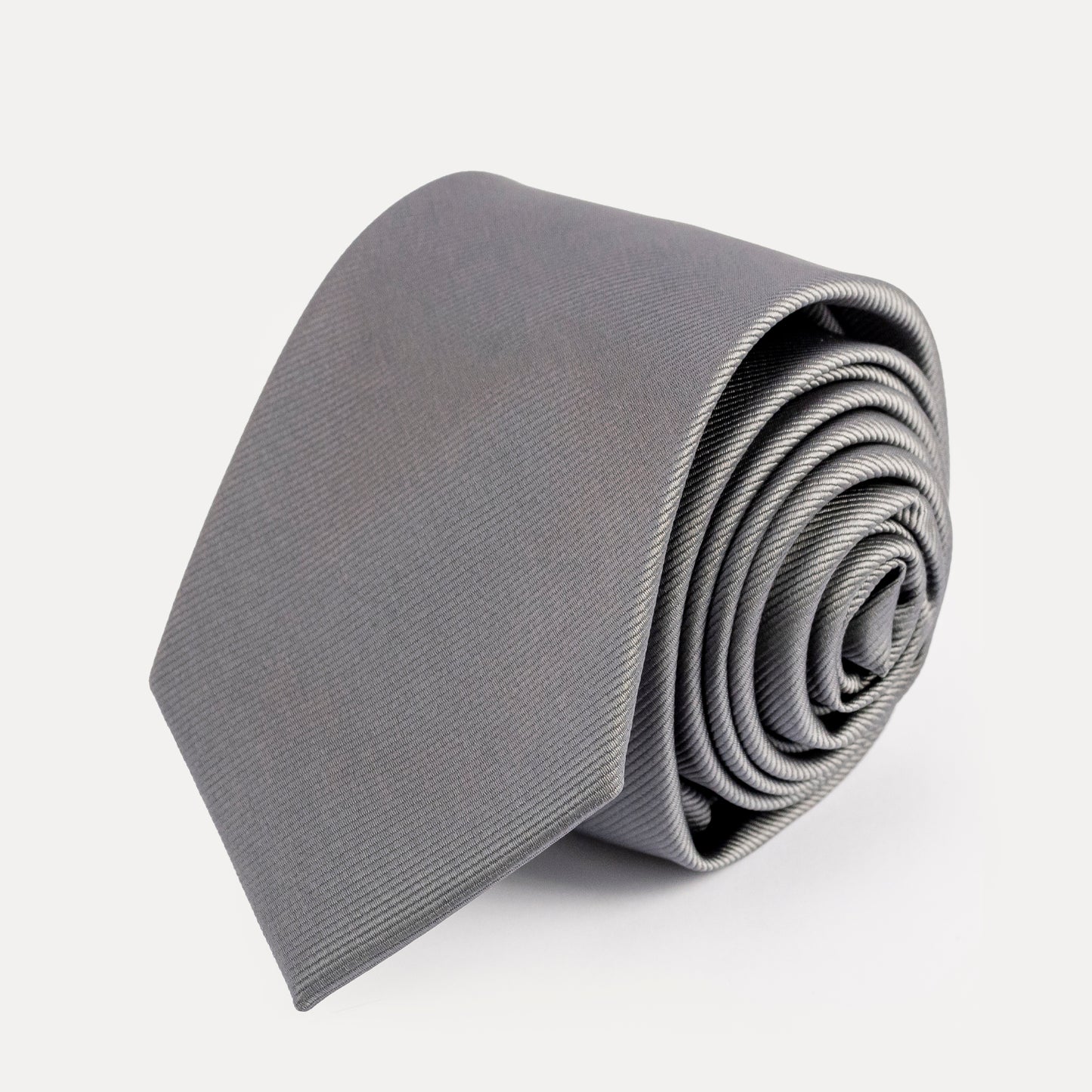 Rolled gray tie on a white background