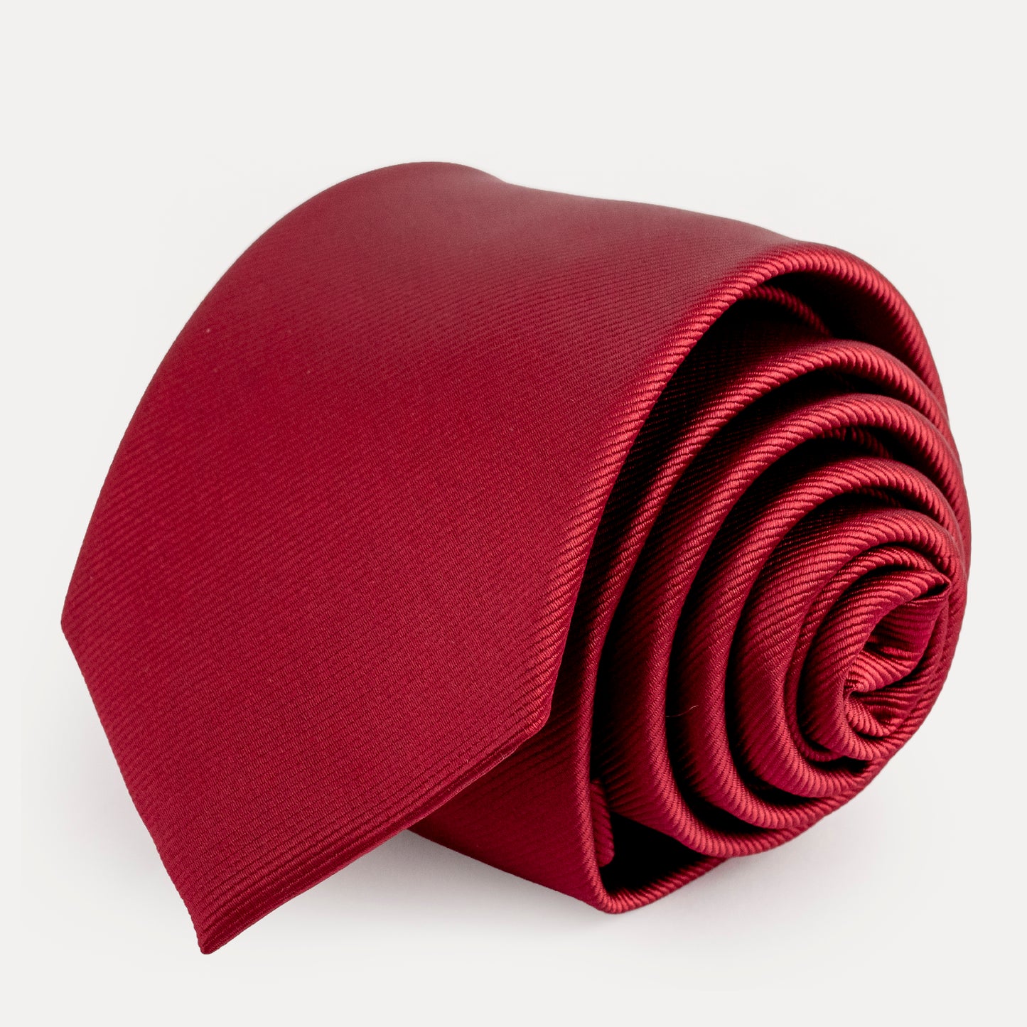 Folded red tie on a white background