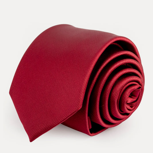 Folded red tie on a white background