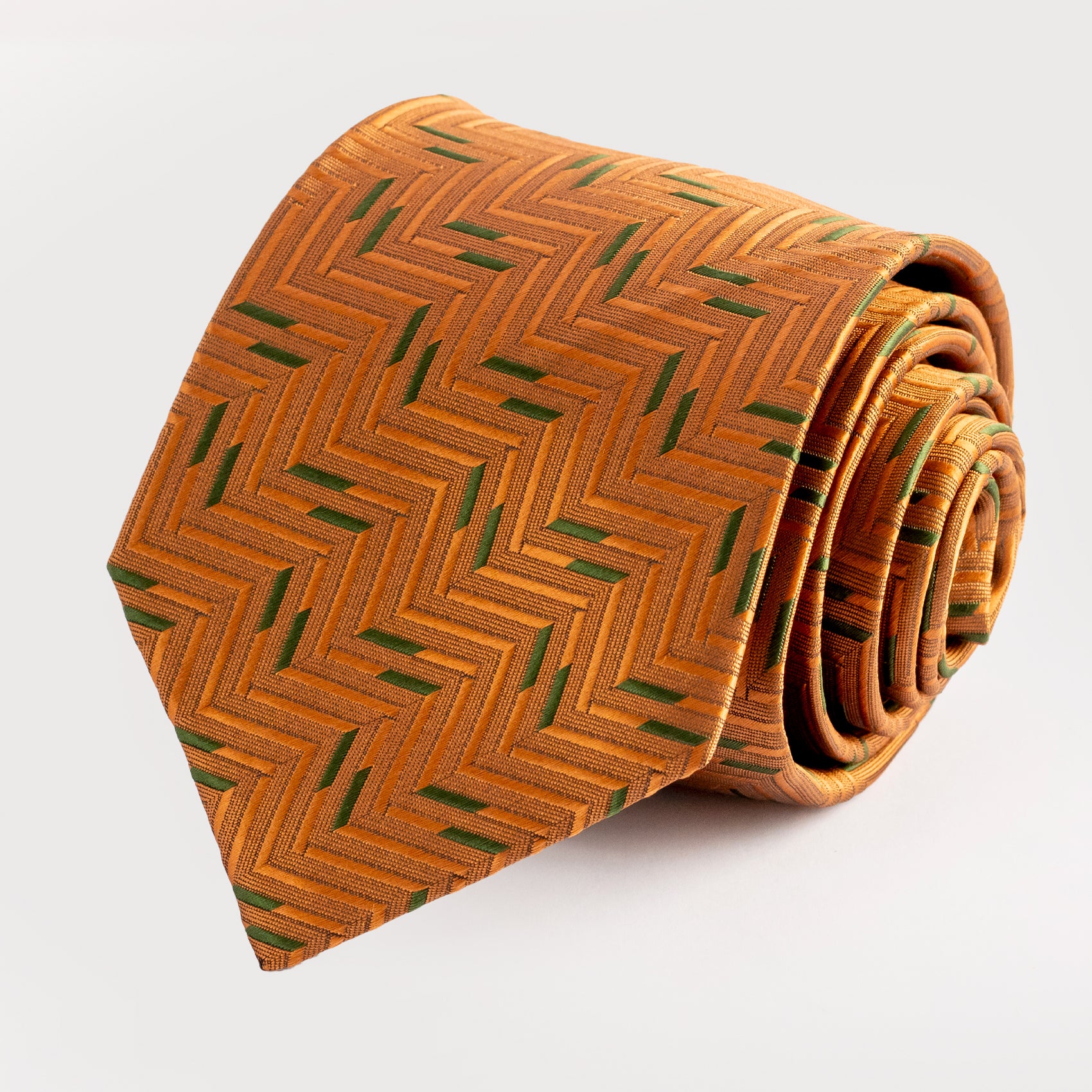 Brown tie with green pattern on a white background